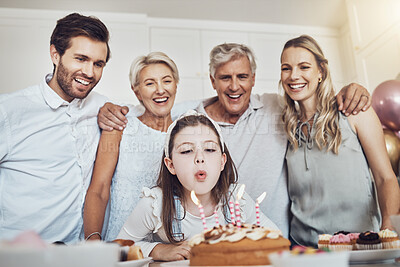 Buy stock photo Cake, birthday and big family with girl blowing out candles for wish, party or celebration event. Love, food and kid with happy father, mother and grandparents celebrating special day in home kitchen