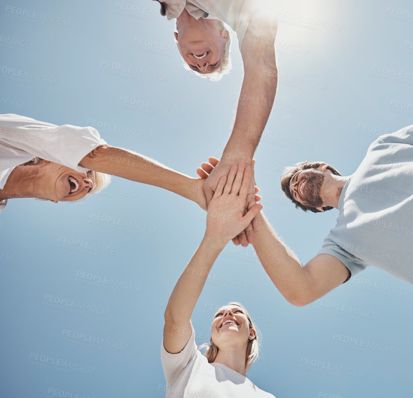 Buy stock photo Low angle, friends and family with hands together, sunlight and support outdoor, bonding and team building. Teamwork, group and collaboration stack for solidarity, partnerships and fun on summer trip