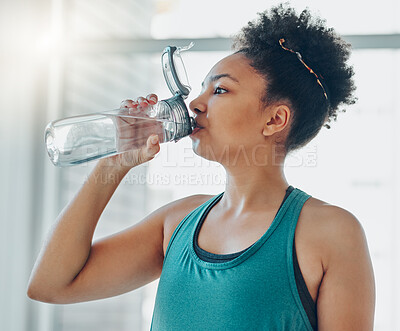 Buy stock photo Drinking water, black woman and fitness of a athlete in a gym after workout and sport. Hydration, drink and healthy young person in a wellness and health center with bottle for training and exercise 