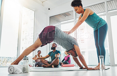 Yoga instructor, exercise and people in class for fitness, health and wellness together. Healthy people in a pilates studio for workout, performance training and stretching for body balance with help