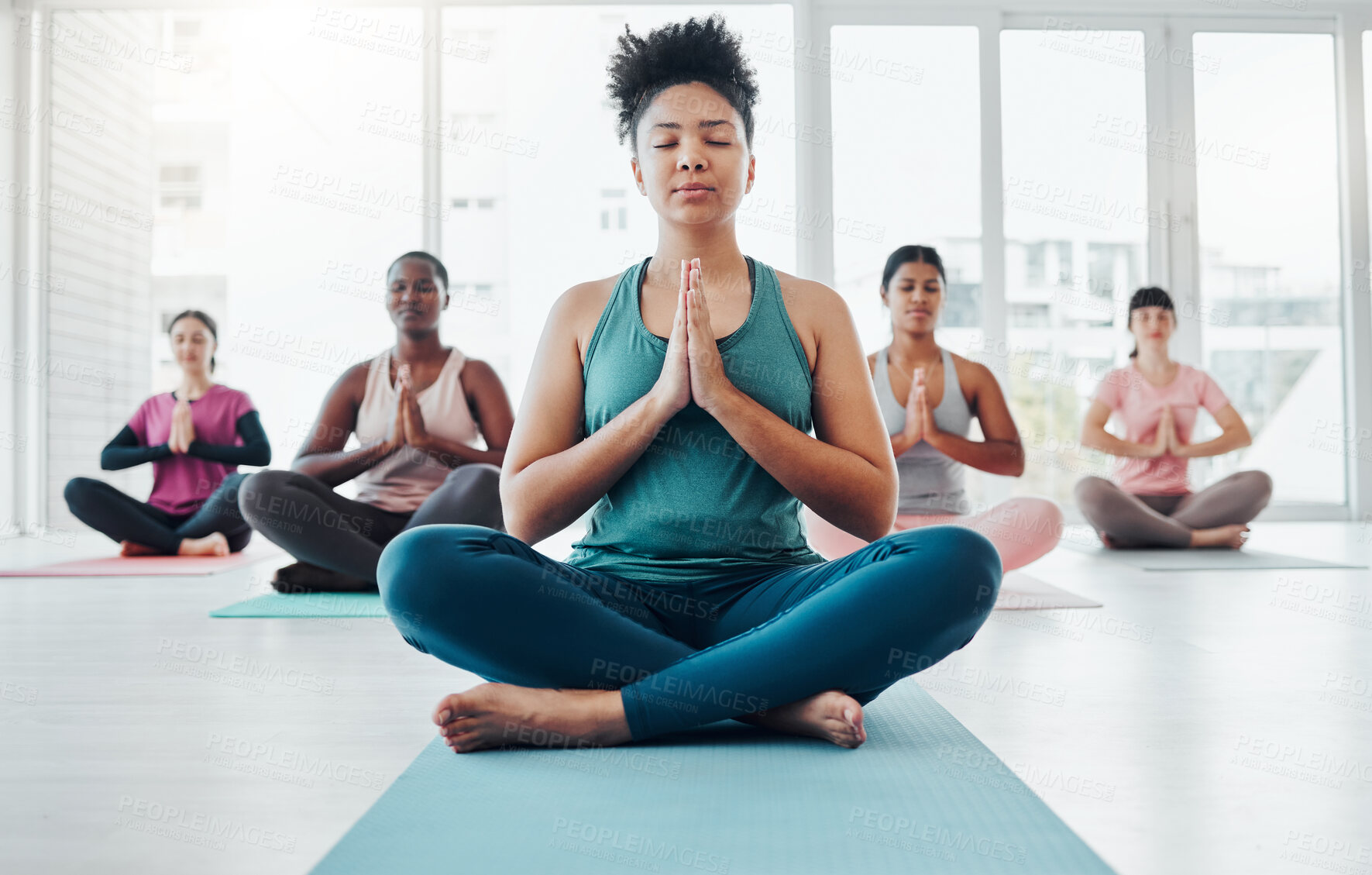 Buy stock photo Yoga class, meditation and a black woman doing exercise for fitness, peace and wellness. Coach and diversity group in health studio for holistic workout, mental health and balance with prayer hands