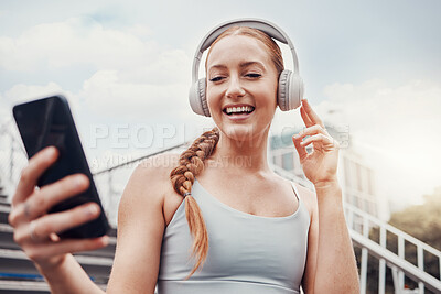 Buy stock photo Fitness, woman and phone with headphones in the city for music listening, 5G connection or workout motivation. Happy female runner smile for headset, smartphone or audio track for exercise on stairs