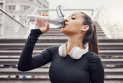 Buy stock photo Workout, hydration and a sports woman drinking water outdoor in the city during cardio or endurance exercise. Runner, fitness and hydrated with a female athlete training in an urban town for health