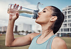 Fitness, woman and drinking water in the city after running, exercise or cardio workout in Cape Town. Female runner with bottle and natural drink for thirst, hydration or aqua liquid for sports break