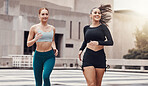 Women, friends running and together in city for workout, wellness and healthy strong body for teamwork in morning. Woman training group, exercise or runner team in metro with support, smile and happy