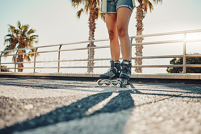 Buy stock photo Hobby, ground and legs of a woman on rollerskates for the weekend, fun activity and summer in Miami. Learning, urban and feet of a girl rollerskating on the floor in the urban city for a cool sports