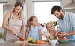 Mom, dad and children cooking with vegetables ingredients for lunch, dinner or meal prep. Family, food and parents with girls learn, development and help in kitchen for nutrition, diet and wellness