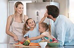 Family, parent and children cooking in kitchen with vegetables for healthy diet, nutrition or meal prep. Bonding, smile and mom, dad and girls learning, teaching and helping cut food ingredients