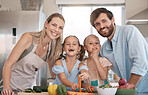 Portrait of mom, dad and children cooking in kitchen with vegetables for healthy lunch, food or diet. Family, smile and parents with girls learn chef skills and help cut ingredients for meal prep