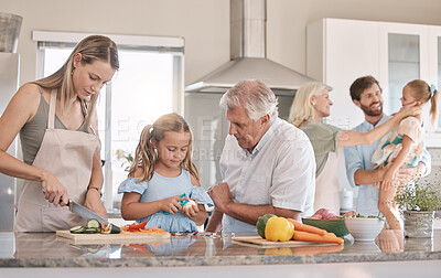 Buy stock photo Big family, cooking and vegetables with a child helping mother and grandfather in the kitchen. Woman, man and girl kid learning to make lunch or dinner with love, care and bonding over food together