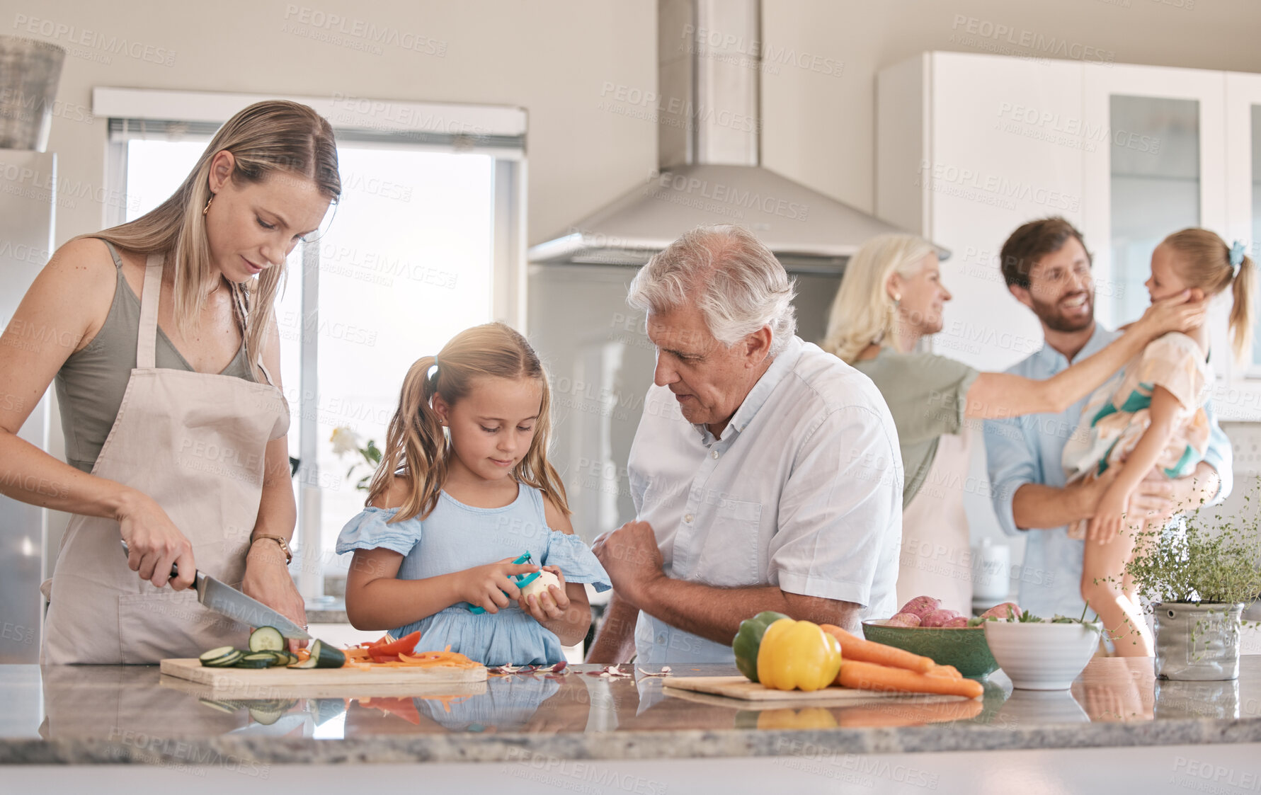 Buy stock photo Big family, cooking and vegetables with a child helping mother and grandfather in the kitchen. Woman, man and girl kid learning to make lunch or dinner with love, care and bonding over food together