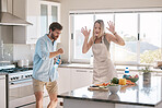 Happy couple, cooking and dancing together in kitchen, home and comic time with happiness, bonding and love. Man, woman and dance in house with vegetables, food and funny moment with hands in air