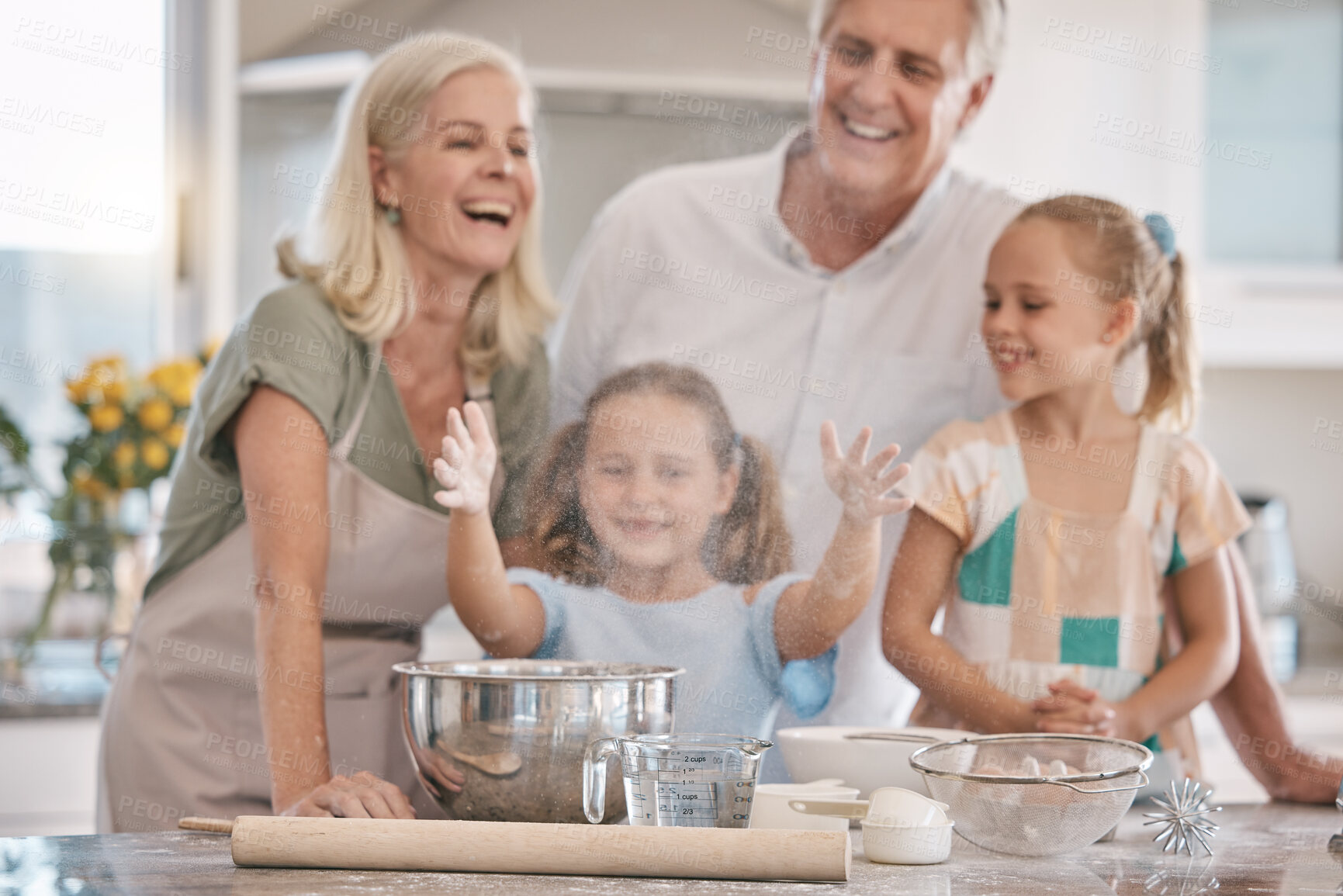 Buy stock photo Love, grandparents and girls baking, quality time and bonding on weekend, break and happiness. Child development, granny and granddad with female grandchildren, fun and loving together and cooking