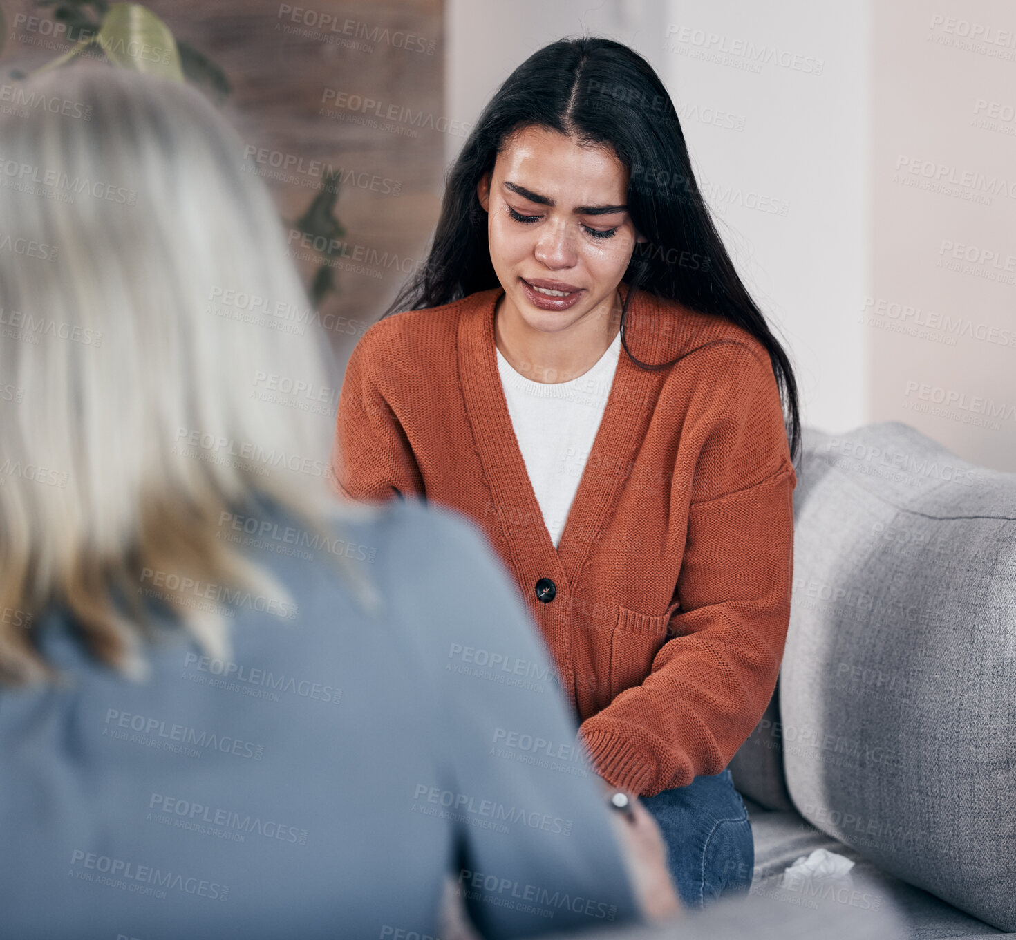 Buy stock photo Sad woman, therapist and crying in consultation for addiction, mental health or support counseling. Female patient and counselor or shrink helping solve issue in healthcare, therapy session or advice