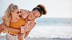 Piggyback, friends and women at beach on holiday, vacation or summer trip outdoors. Travel, diversity and girls or females having fun, laughing at joke and enjoying time together by ocean or seashore