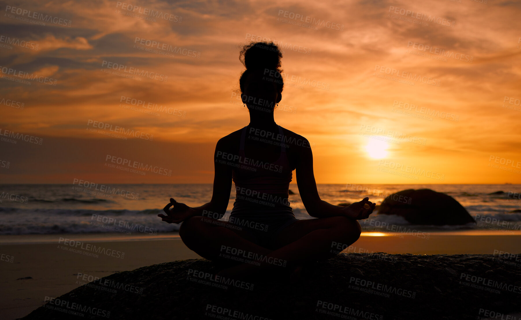Buy stock photo Sunset, beach and silhouette of a woman in a lotus pose while doing a yoga exercise by the sea. Peace, zen and shadow of a calm female doing meditation or pilates workout outdoor at dusk by the ocean