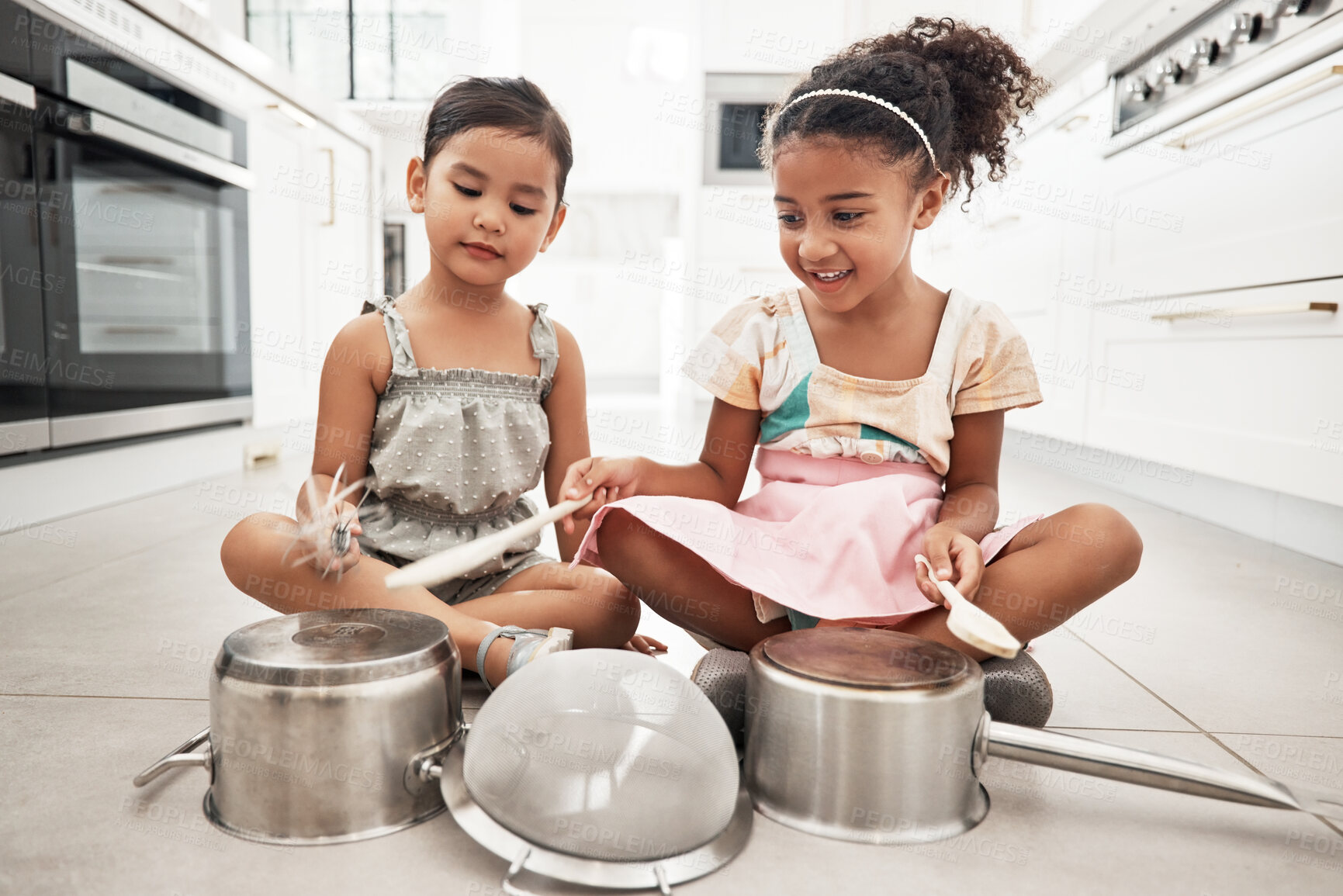 Buy stock photo Girl children are playing house, pots as drums and happy, care free at family home and make believe with music fun. Noise, metal and kids on floor, play date together and fantasy with imagination