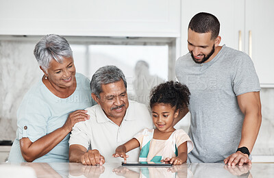 Buy stock photo Learning, big family and girl with tablet in home, playing online games or educational app. Bonding, touchscreen or care of happy grandparents and father teaching kid how to use technology in kitchen