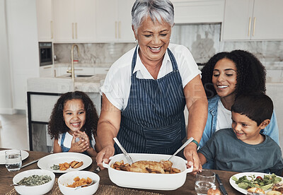 Buy stock photo Grandmother, family home and kids at table for food, lunch or celebration with love, care and happiness. Black people, senior woman and children with dinner, party and happy for bonding in kitchen