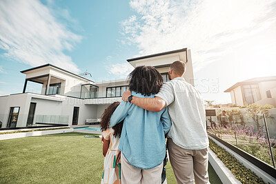 Buy stock photo Love, new home and family standing in their backyard looking at their property or luxury real estate. Embrace, mortgage and parents with their children on grass at their house or mansion in Canada.