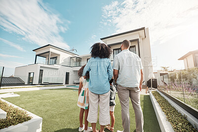 Buy stock photo Love, new house and family in their backyard together looking at their property or luxury real estate. Embrace, mortgage and parents with their children on grass at their home or mansion in Canada.