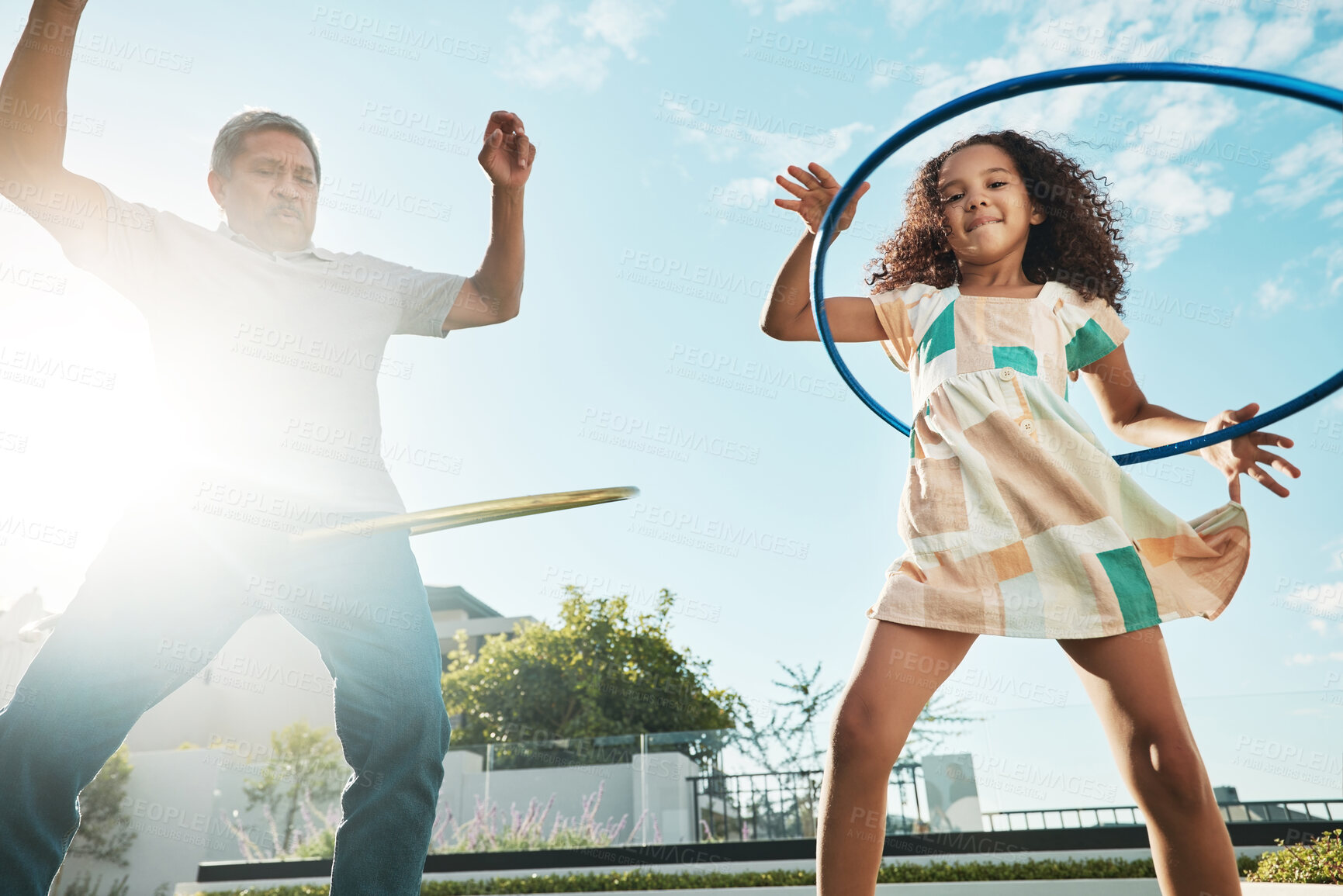 Buy stock photo Grandfather, girl child and family hula hoop in city, having fun and bonding together outdoors. Love, portrait and low angle of grandpa and kid playing with hoops toy, dance and enjoying quality time