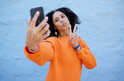 Buy stock photo Selfie, pose and woman by a wall in the city while on a travel holiday or weekend trip in Mexico. Freedom, peace sign and female taking a picture with a hand gesture in a urban town on a vacation.