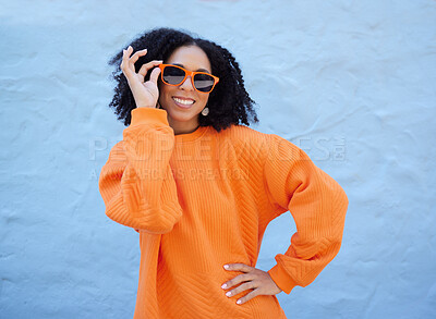 Buy stock photo Trendy portrait, sunglasses and black woman isolated on blue background gen z, youth or fashion clothes. Happy person or beauty model in confidence, vision style and orange color on brick wall mockup