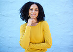 Portrait, proud and black woman in studio on mockup, space and blue background for advertising. Face, smile and girl relax on backdrop, cheerful and confident, relax and posing inside on copy space