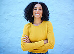 Proud, portrait and black woman in studio on mockup, space and blue background for advertising. Face, smile and girl relax on backdrop, cheerful and confident, relax and posing inside on copy space