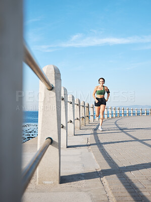 Buy stock photo Fitness, woman and running by the beach side for exercise, training or cardio workout in Cape Town. Active female runner enjoying summer run or exercising for healthy wellness in the nature outdoors