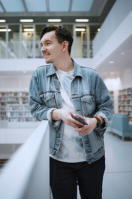 Buy stock photo Education, college and man student in the library for studying, learning or researching for a test. University, scholarship and male standing in a book store to work on a school task, exam or project