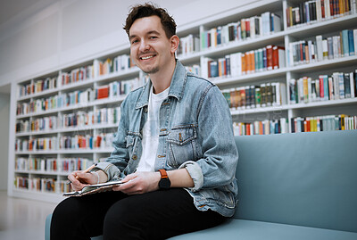 Buy stock photo Student man, library portrait and writing on sofa with smile, happy and focus on education at college. University student, pen and notebook for notes, goals and ideas for studying, research and task