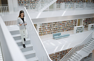 Buy stock photo Walking student, tablet or woman in library for social media, education or learning. Bookshelf, books or girl on tech for scholarship networking, search or planning school project at collage campus