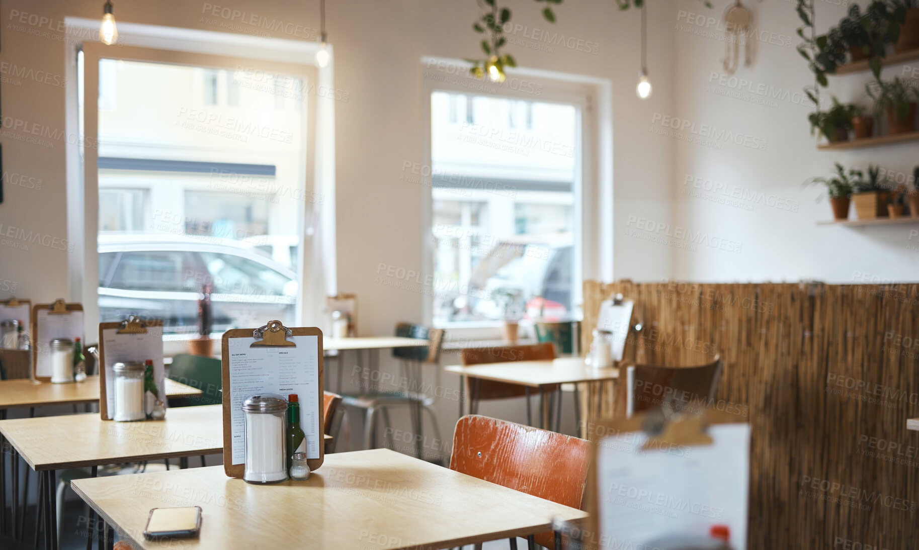 Buy stock photo Table, chair and menu in an empty coffee shop in the city ready for service on opening day. Furniture, restaurant and decor on the interior of a small business cafe in the morning waiting to serve