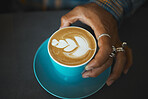 Latte art, coffee and barista hand with leaf design, caffeine and artistic product with pattern in cafe. Creative, man and drawing with milk foam, hospitality with service and beverage closeup