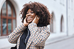 Black woman, earphones and listening to music in the city streets with smile for entertainment. Happy African American female walking in a urban town smiling in joyful happiness for audio sound track