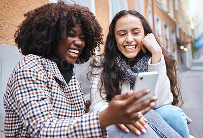 Buy stock photo Friends, city and women with phone for social media, conversation and connection on London street. Communication, internet and happy black woman and girl on smartphone smile for selfie, app and meme