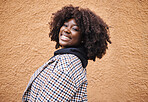 Black woman, portrait and smile on wall background in city, urban town and Kenya. Happy plus size african female with natural afro, happiness and confidence outdoors with fashion, relax and freedom