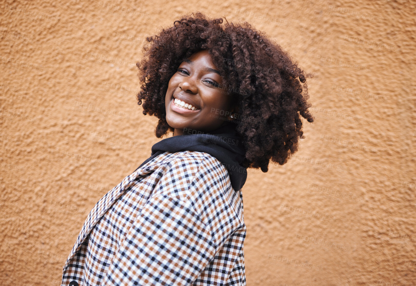 Buy stock photo Black woman, portrait and smile on wall background in city, urban town and Kenya. Happy plus size african female with natural afro, happiness and confidence outdoors with fashion, relax and freedom