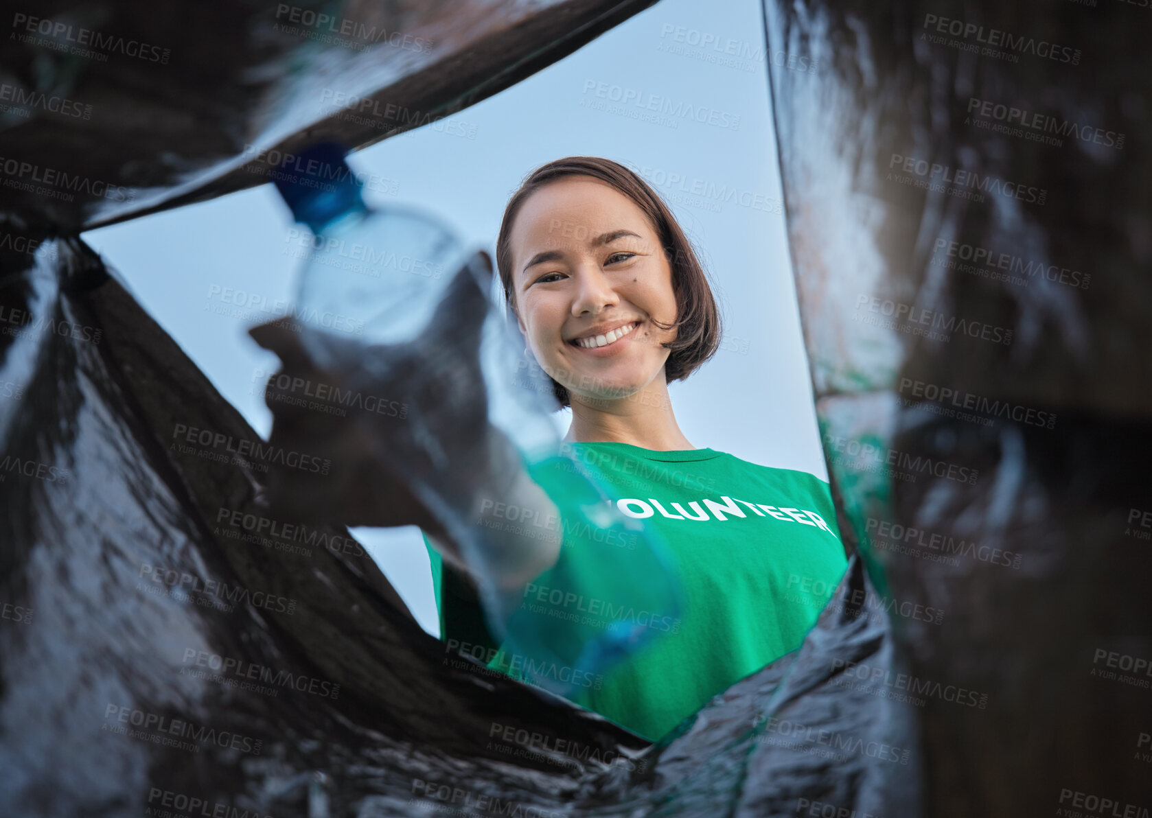 Buy stock photo Recycle, bottle and asian woman with view in bag, sustainability and cleaning plastic pollution, earth day and help with community. Saving the environment, charity and people putting trash in garbage