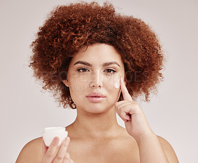 Buy stock photo Skincare, beauty and portrait of black woman with lotion on face, afro and advertising luxury skin product promotion. Dermatology, cosmetics and facial, model with jar isolated on studio background.