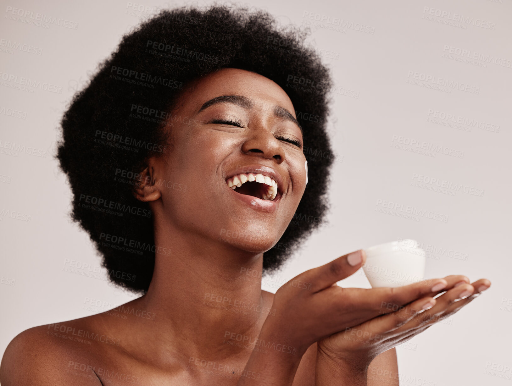 Buy stock photo Skin care, beauty cream and a black woman in studio happy with dermatology cosmetic container. Aesthetic model with hands for product placement for health, wellness and face skin glow grey background
