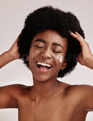 Buy stock photo Skincare, beauty and black woman with afro and cream on face, smile and advertising luxury skin product promotion. Dermatology, cosmetics and spa facial for happy model isolated on studio background