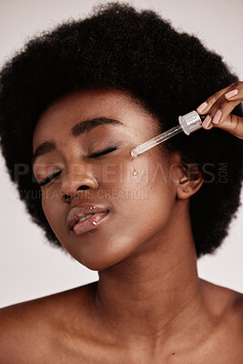 Buy stock photo Face serum, skin care and beauty of black woman in studio with dermatology cosmetic oil. Aesthetic model with hands for collagen product for health, wellness and facial skin natural youth glow
