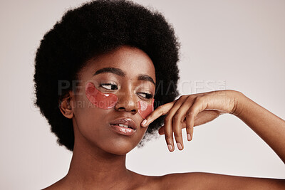 Buy stock photo Skin care, eye mask and a black woman in studio with dermatology cosmetic product. Aesthetic model with hands for collagen gel patch for health, wellness and beauty face skin glow on grey background