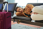 Tired, sleeping and woman at airport, waiting and bench for travel, international transport and flight delay. Tourist nap on chair at airplane lounge before journey with baggage, luggage and suitcase