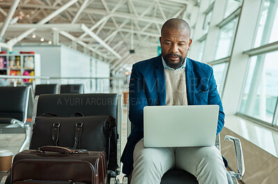 Buy stock photo Black man, laptop and luggage at airport for business travel, trip or working while waiting to board plane. African American male at work on computer checking online schedule times for flight delay