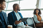 Airport, travel and talking with business people waiting in a departure lounge for an international flight. Global, transport or journey with a man and woman sitting in line in a terminal for flying