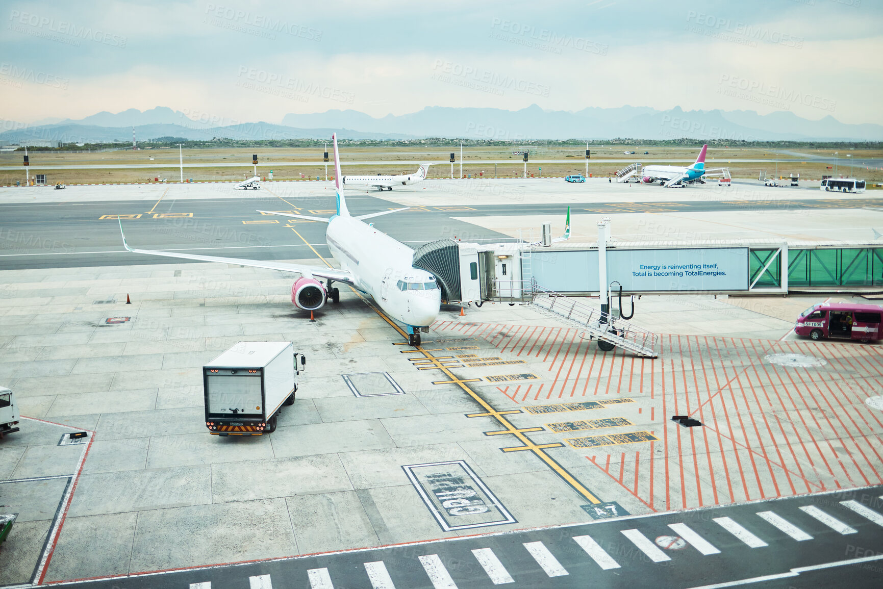 Buy stock photo Airplane at airport, stationary aircraft on tarmac and runway for international passenger travel on sky horizon. Plane on ground, outdoor flight terminal and cargo carrier on aeroplane runway